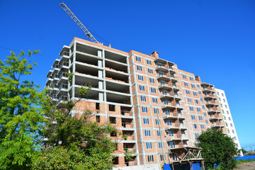 Building construction. Building house with Tower Crane Construction Assembly. House construction.