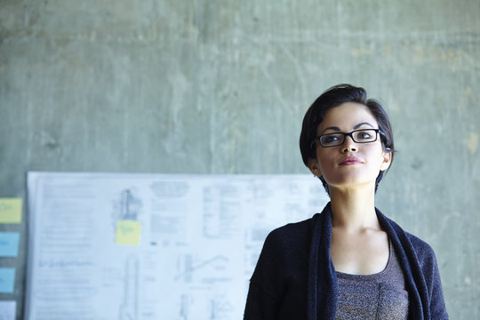 Portrait of serious young businesswoman in office
