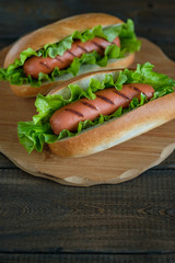 Hotdogs on a wooden board. Photo closeup.