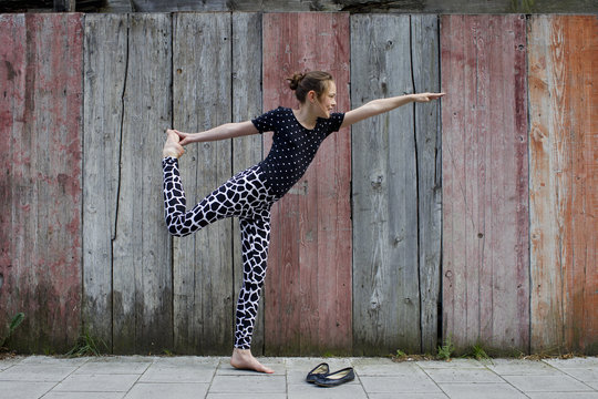 Teenage girl standing on one leg