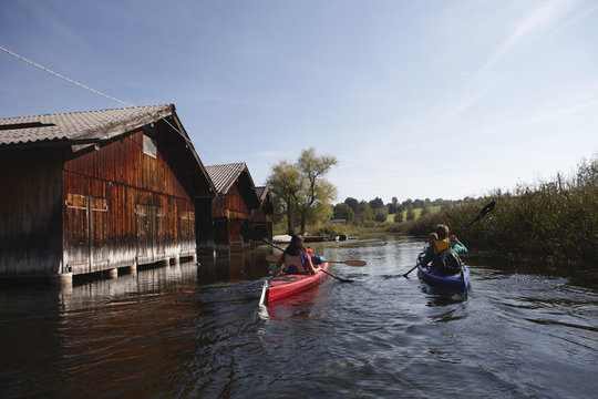 Family canoeing on lake, Staffelsee, Murnau, Oberbayern, Bavaria, Germany