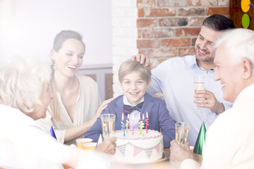 Family celebrating boy's birthday