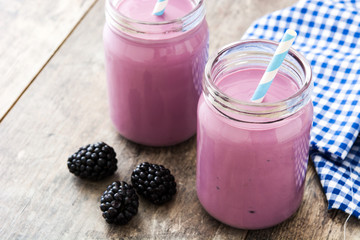 Healthy blackberry smoothie in glass on wooden table

