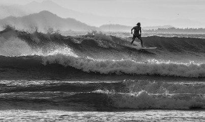 Fototapeta na wymiar Surfer rides the ocean wave