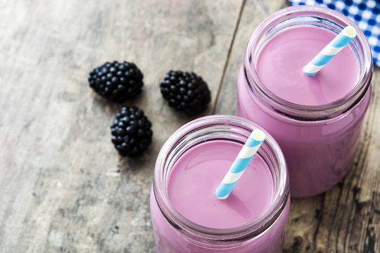 Healthy blackberry smoothie in glass on wooden table

