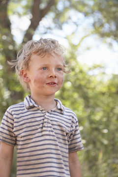 Portrait of young boy with dirty face