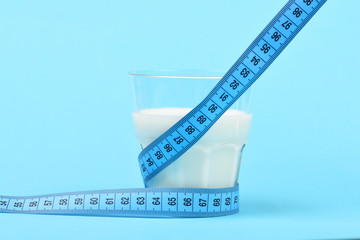 Tape for measuring wraps around glass of milk