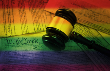 Rainbow flag gavel on America's Constitution