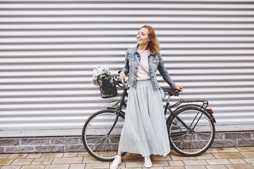 Fashionable woman with urban bike