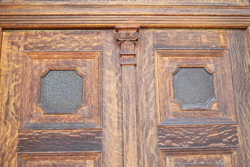 Old carved wood door with glass panels