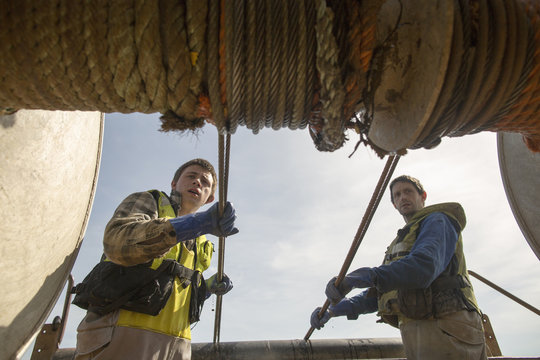 Fishermen reeling in net