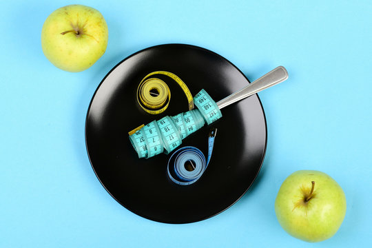 Pair of apples and colorful measuring tapes