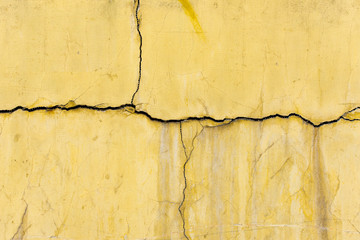 Old vintage yellow concrete crack wall