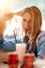 Woman drinking milkshake at the restaurant 