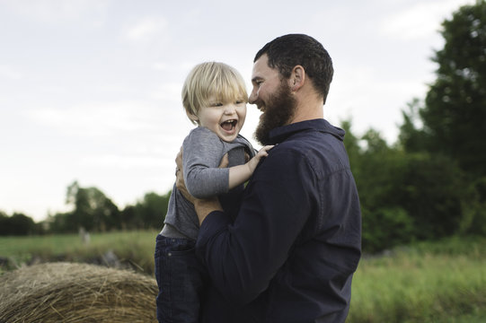 Father holding son, outdoors