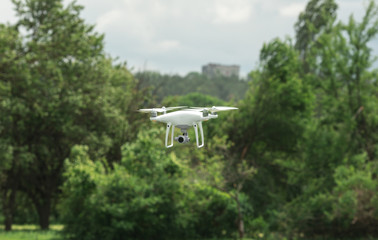 Closeup shot of a small drone flying above green lawn