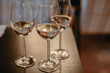 Row of glasses with white wines prepared for tasting