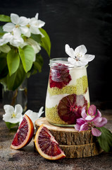 Detox layered matcha green tea chia seed pudding with blood oranges. Vegan dessert with coconut whipped cream. Healthy vegetarian breakfast, dieting, weight loss food