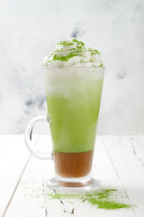 Matcha latte with salted caramel in tall glass.