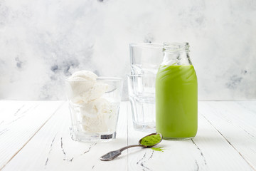 Preparing matcha green tea affogato with vegan coconut ice cream. Copy space