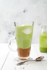 Matcha latte with salted caramel in tall glass.