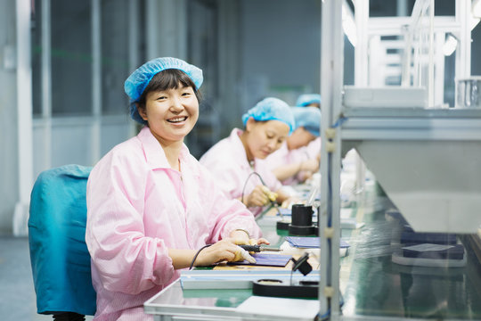 Female workers in solar panel assembly factory, Solar Valley, Dezhou, China
