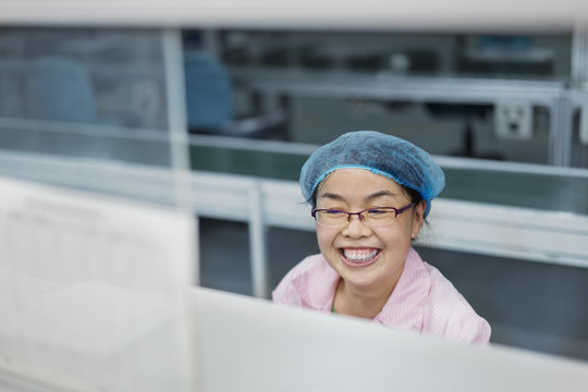 Female worker in solar panel assembly factory, Solar Valley, Dezhou, China