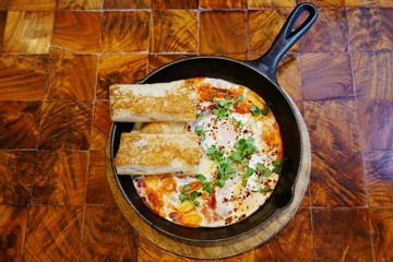 Shakshouka dish of eggs poached in tomato sauce