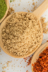 Three Spices in Wood Spoons White Background