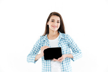 Portrait of a young girl showing blank screen tablet computer