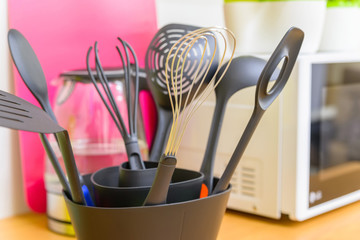 Modern plastic kitchen utensils in stand