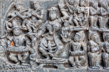 Music band playing and dancing in traditional Indian form. Relief of the 12th century Hindu temple Hoysaleshwara in Halebidu, India