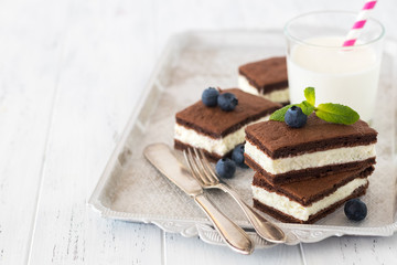 Chocolate biscuit with milk filling and berries on a plate. Chocolate-milk kids dessert. - 159610769