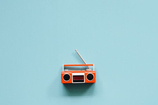 vintage radio and recording music over blue background