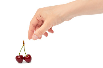 Beautiful female hand holds cherry gesture. Isolated on white background