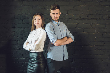 business team male and female formed of young businessmen standing over a dark background