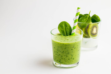 .Green smoothies made of yogurt, spinach, kiwi and apple in glasses on a white background, ingredients around - 159611514