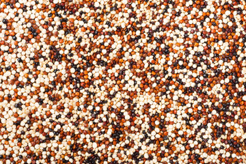food background of uncooked quinoa, top view