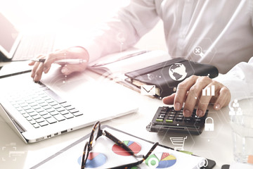 businessman hand working with finances about cost and calculate  and latop with mobile phone on withe desk in modern office