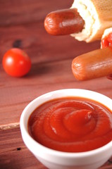 Two hot dogs with ketchup