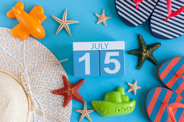 July 15th. Image of july 15 calendar with summer beach accessories and traveler outfit on background. Summer day, Vacation concept