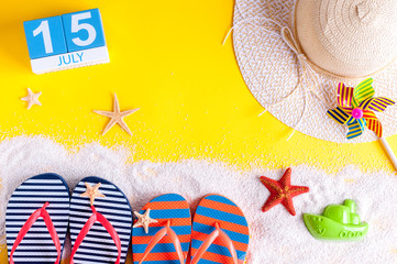 July 15th. Image of july 15 calendar with summer beach accessories and traveler outfit on...