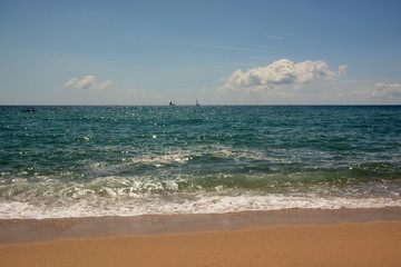 Fototapeta na wymiar Clean sandy beach and turquoise sea of Barcelona