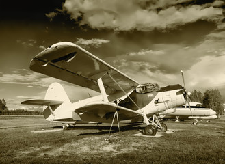 Old plane biplane on the airfield. Sepia toning.
