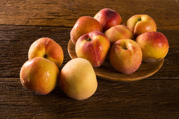 Nectarines on wooden table.