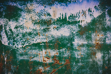 Rusted iron, covered with green and white paint. White stains of paint. background texture surface