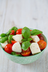 caprese salad on turquoise background