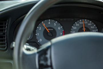 The wheel of the car with gauges and a speedometer 110 km / h
