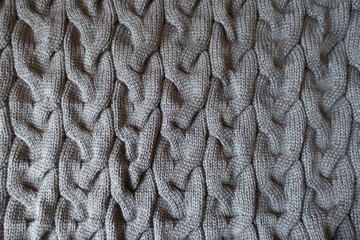 Plait pattern on grey knit fabric from above