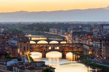 View of the Ponte Vecchio bridge over the Arno River in Florence with floodlight